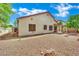 Back exterior view of house featuring minimal desert landscaping and covered patio area at 9142 Royal Monarch Ct, Las Vegas, NV 89147
