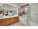 Bathroom featuring a soaking tub, stand-up shower, and double vanity at 9142 Royal Monarch Ct, Las Vegas, NV 89147