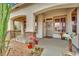 Close up of a charming home entrance, decorated with plants and a decorative wreath at 9142 Royal Monarch Ct, Las Vegas, NV 89147