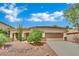 Charming home with desert landscaping, a two-car garage, and a welcoming entryway at 9142 Royal Monarch Ct, Las Vegas, NV 89147