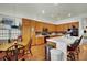 Cozy eat-in kitchen featuring wood cabinets, stainless steel appliances and an island with bar seating at 9142 Royal Monarch Ct, Las Vegas, NV 89147