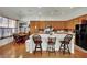 Well-lit kitchen with wood cabinets, a large island, and seating at the breakfast bar at 9142 Royal Monarch Ct, Las Vegas, NV 89147