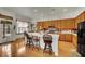Open kitchen with wood cabinets, stainless steel appliances, and an island with bar seating at 9142 Royal Monarch Ct, Las Vegas, NV 89147