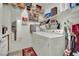 Functional laundry room featuring a washer, dryer, storage shelves, and mirrored door at 9142 Royal Monarch Ct, Las Vegas, NV 89147