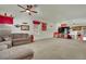 Large carpeted living room with abundant light and a comfortable sectional sofa at 9142 Royal Monarch Ct, Las Vegas, NV 89147