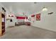 Spacious living room featuring a cozy sectional sofa, ceiling fan, and neutral carpet at 9142 Royal Monarch Ct, Las Vegas, NV 89147