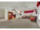 Open-concept living room with large carpeted area, ceiling fan, and doorway at 9142 Royal Monarch Ct, Las Vegas, NV 89147