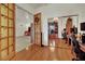 View of an organized office space with hardwood floors, desks, and sliding mirror door at 9142 Royal Monarch Ct, Las Vegas, NV 89147