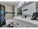 Nicely decorated bathroom featuring tiled shower/tub, vanity with a sink and modern lighting at 100 Huntly Rd, Las Vegas, NV 89145