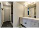 Bright bathroom features modern vanity with white countertop and tiled shower with glass door at 100 Huntly Rd, Las Vegas, NV 89145
