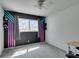 This bedroom features carpet, a ceiling fan, and an accent wall with custom geometric paint design at 100 Huntly Rd, Las Vegas, NV 89145
