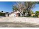 Charming one-story home with a well-maintained lawn and mature trees at 100 Huntly Rd, Las Vegas, NV 89145