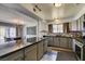 Open kitchen with stainless steel appliances, granite countertops, and wood-style flooring at 100 Huntly Rd, Las Vegas, NV 89145