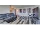 Inviting living room featuring wood-style flooring, a gray sofa, and vibrant guitar wall art at 100 Huntly Rd, Las Vegas, NV 89145
