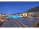 Outdoor living space with a pool, modern patio, and fire pit, perfect for relaxation at 10048 Copper Edge Rd, Las Vegas, NV 89148