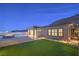 Beautiful backyard features a modern pool, a fire pit, and a manicured lawn at 10048 Copper Edge Rd, Las Vegas, NV 89148