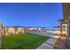 Stunning backyard with a modern pool, a cozy fire pit, and lush green turf at 10048 Copper Edge Rd, Las Vegas, NV 89148