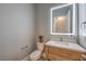 Compact powder room features wood vanity, white marble countertop, and a modern LED mirror at 10048 Copper Edge Rd, Las Vegas, NV 89148
