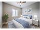 Cozy bedroom featuring coastal decor, ceiling fan, and plantation shutters at 10048 Copper Edge Rd, Las Vegas, NV 89148
