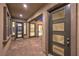 An elegant home entryway featuring paneled doors and brick flooring at 10048 Copper Edge Rd, Las Vegas, NV 89148