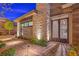 Elegant home exterior showcasing stone accents, manicured landscaping, and a private gate at 10048 Copper Edge Rd, Las Vegas, NV 89148