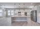 Modern white kitchen featuring an island, stainless steel appliances, and ample cabinet space at 10048 Copper Edge Rd, Las Vegas, NV 89148