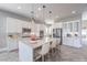 Modern kitchen features a large island, stainless steel appliances, and pendant lighting at 10048 Copper Edge Rd, Las Vegas, NV 89148