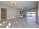 Large living room with fireplace, ceiling fan, and pool view at 10048 Copper Edge Rd, Las Vegas, NV 89148