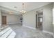 Open-concept living area with chandelier and view of the kitchen at 10048 Copper Edge Rd, Las Vegas, NV 89148