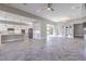 A spacious living room features Herringbone floors, high ceilings, recessed lighting, and adjoins a bright kitchen at 10048 Copper Edge Rd, Las Vegas, NV 89148