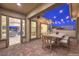 Inviting outdoor patio with dining area and string lights, seamlessly blending indoor and outdoor living at 10048 Copper Edge Rd, Las Vegas, NV 89148