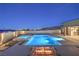 Night view of a modern pool and spa with a fire feature, perfect for evening relaxation and entertainment at 10048 Copper Edge Rd, Las Vegas, NV 89148