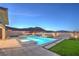 Tranquil backyard pool and spa at dusk, complemented by desert landscaping and mountain scenery at 10048 Copper Edge Rd, Las Vegas, NV 89148