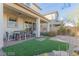 Outdoor patio area with a table and chairs, a seating area, and artificial turf at 10316 Apefly St, Las Vegas, NV 89141