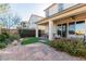 Well-maintained backyard with brick patio, lush landscaping, and a covered seating area at 10316 Apefly St, Las Vegas, NV 89141