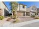 Two-story stucco home with a brick-paved driveway, a brown garage door, and landscaping at 10316 Apefly St, Las Vegas, NV 89141