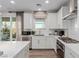 Bright kitchen features stainless steel appliances, white cabinets, and a view to the back patio at 10316 Apefly St, Las Vegas, NV 89141