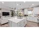 Open concept living space with kitchen featuring stainless appliances and large island connected to the living room at 10316 Apefly St, Las Vegas, NV 89141