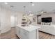 Open concept living space with a kitchen featuring a large island, seamlessly connected to the living room area at 10316 Apefly St, Las Vegas, NV 89141