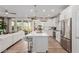 Bright and modern kitchen with stainless steel appliances and island seating, open to the living area at 10316 Apefly St, Las Vegas, NV 89141
