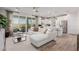 Inviting living space with a white sofa, open to a modern kitchen, and backyard views through sliding glass doors at 10316 Apefly St, Las Vegas, NV 89141