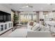Open concept living area with a cozy sectional sofa, and views of the backyard through sliding glass doors at 10316 Apefly St, Las Vegas, NV 89141