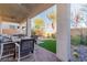Covered outdoor patio featuring a dining table, chairs, and a view of the landscaped backyard at 10316 Apefly St, Las Vegas, NV 89141