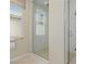 Modern bathroom featuring a glass-enclosed shower with white subway tile and a window for natural light at 10316 Apefly St, Las Vegas, NV 89141