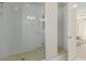 Glass walk-in shower with white subway tile and a beige floor, adjacent to an opening into the bedroom at 10316 Apefly St, Las Vegas, NV 89141