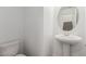 Modern half-bathroom with pedestal sink and white fixtures at 10328 Apefly St, Las Vegas, NV 89141