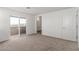 Carpeted bedroom featuring a balcony, door into the bathroom, and a hall entrance at 10328 Apefly St, Las Vegas, NV 89141