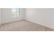 Bedroom with neutral carpet, base trim and large windows at 10328 Apefly St, Las Vegas, NV 89141