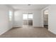 Carpeted bedroom with balcony access and a view of the bathroom at 10328 Apefly St, Las Vegas, NV 89141