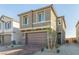 Inviting two-story home featuring a brick driveway, stone accents and a two-car garage at 10328 Apefly St, Las Vegas, NV 89141